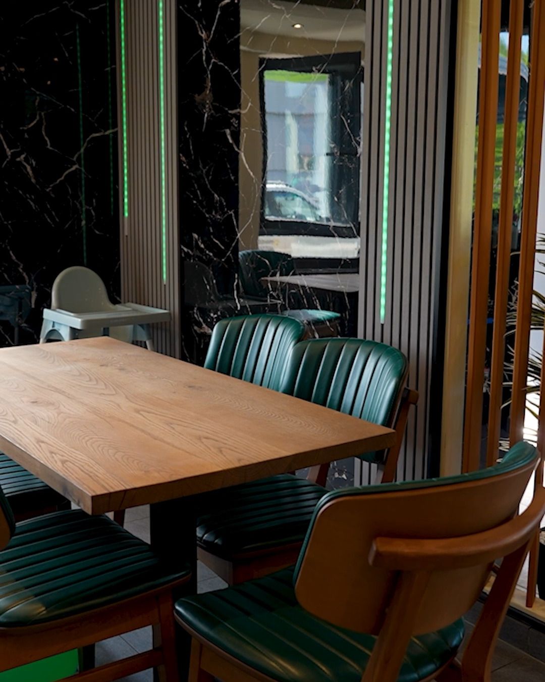 Restaurant with glazed terrace, Lausen BL — Marble finish, timber slats, green light line (Still from video)