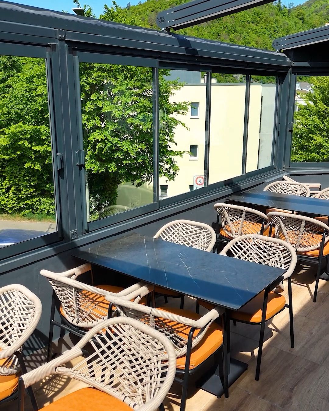 Restaurant with glazed terrace, Lausen BL — Glazed terrace under a pergola roof (Still from video)